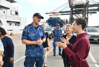 Minister of Foreign Affairs and Foreign Trade, Senator the Hon. Kamina Johnson Smith (right), converses with Captain of the HNLMS Pelikaan, Max Borsboom (left), during the arrival of relief supplies from Barbados at the Kingston Freeport Container Terminal on Wednesday (November 12). Also present is European Union (EU) Ambassador to Jamaica, Erja Askola.