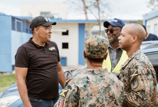 Minister of Health and Wellness, Dr. the Hon. Christopher Tufton (left) engages in discussion with Chief Executive Officer of the Savanna-la-Mar Public General Hospital, Roan Grant (third right)  and members of the Jamaica Defence Force, at the Westmoreland facility on Sunday (November 2).