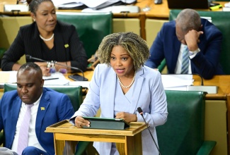 Minister of Education, Skills, Youth and Information, Senator, Dr. the Hon. Dana Morris Dixon, makes a statement in the Senate on November 21. At left is Senator Abka Fitz-Henley.

