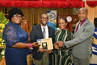 Writer and Producer at the Jamaica Information Service (JIS), Andrae Palmer (second left), who is one of 14 finalists for Civil Servant of the Year 2025, is congratulated by the JIS team (from left) Senior Photo Librarian, Maxine Shrouder; Manager, Human Resource Management and Development, Julian Tomlinson; and Director, Human Resource Management and Development, Dr. David Knight. Due to the impact of Hurricane Melissa, the selection process for this year