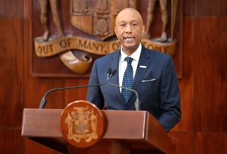 Managing Director, Development Bank of Jamaica (DBJ), Dr. David Lowe, addresses a press briefing at Jamaica House on November 26