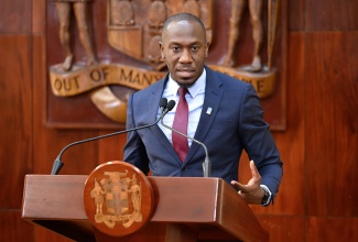 Assistant General Manager for Corporate Communications and Public Affairs of the National Housing Trust, Dwayne Berbick, addresses a Special Press Briefing on Hurricane Melissa Recovery, at the Office of the Prime Minister in Kingston, on November 26.

