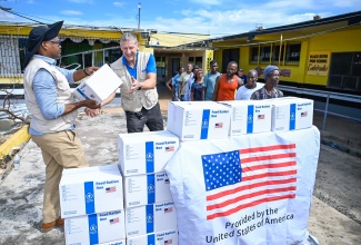 Members of the World Food Programme (WFP) distribute food boxes containing non-perishable items, rice, and vegetable oil – sufficient to sustain a family of three for up to seven days – to residents in St. Elizabeth on Monday (November 10). The occasion formed part of a tour of the Emergency Field Hospital and its facilities at Black River High School, led by Under Secretary of State for Foreign Assistance, Humanitarian Affairs, and Religious Freedom at the United States (US) Department of State, Jeremy Lewin, alongside Minister of Energy, Transport and Telecommunications, Hon. Daryl Vaz, and Member of Parliament for St. Elizabeth South Western and Minister of Agriculture, Fisheries and Mining, Hon. Floyd Green.

