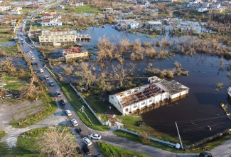 An aerial view of Hurricane Melissa’s aftermath in Black River, St. Elizabeth, captured two days after the category-five system made landfall on October 28. The image shows widespread devastation, including a church stripped of its roof and extensive flooding across the town, following torrential rains that battered the area during the cyclone’s passage.

