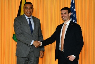 Prime Minister, Dr. the Most Hon. Andrew Holness (left), shakes hands with United Sates Under Secretary for Foreign Assistance, Humanitarian Affairs and Religious Freedom, Jeremy Lewin, following a meeting at the Office of the Prime Minister on Monday (November 10).

