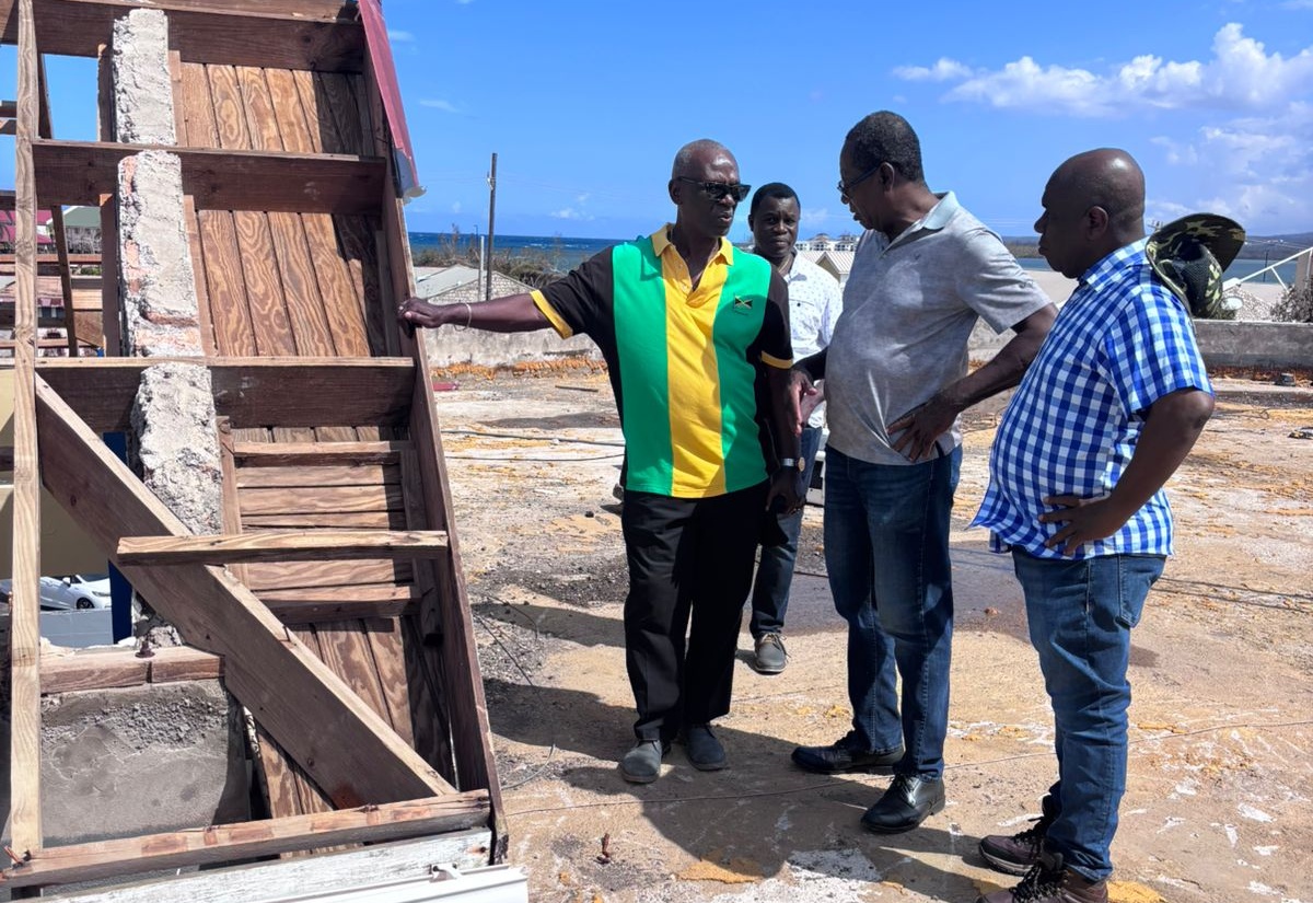 Minister of Local Government and Community Development, Hon. Desmond McKenzie (left) converses with Mayor of Falmouth, Councillor Collen Gager (right) and Divisional Head of the Jamaica Fire Brigade in Trelawny, Roland Walters (centre) at the Falmouth Fire Station in Trelawny.  Occasion was a tour of local government infrastructure in the parish on Saturday (November 8). Looking on is Senior Director of Hazard Mitigation and Risk Management in the Ministry of Local Government and Community Development, Patrick Watson (in background).