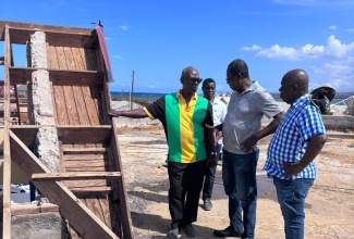 Minister of Local Government and Community Development, Hon. Desmond McKenzie (left) converses with Mayor of Falmouth, Councillor Collen Gager (right) and Divisional Head of the Jamaica Fire Brigade in Trelawny, Roland Walters (centre) at the Falmouth Fire Station in Trelawny.  Occasion was a tour of local government infrastructure in the parish on Saturday (November 8). Looking on is Senior Director of Hazard Mitigation and Risk Management in the Ministry of Local Government and Community Development, Patrick Watson (in background).