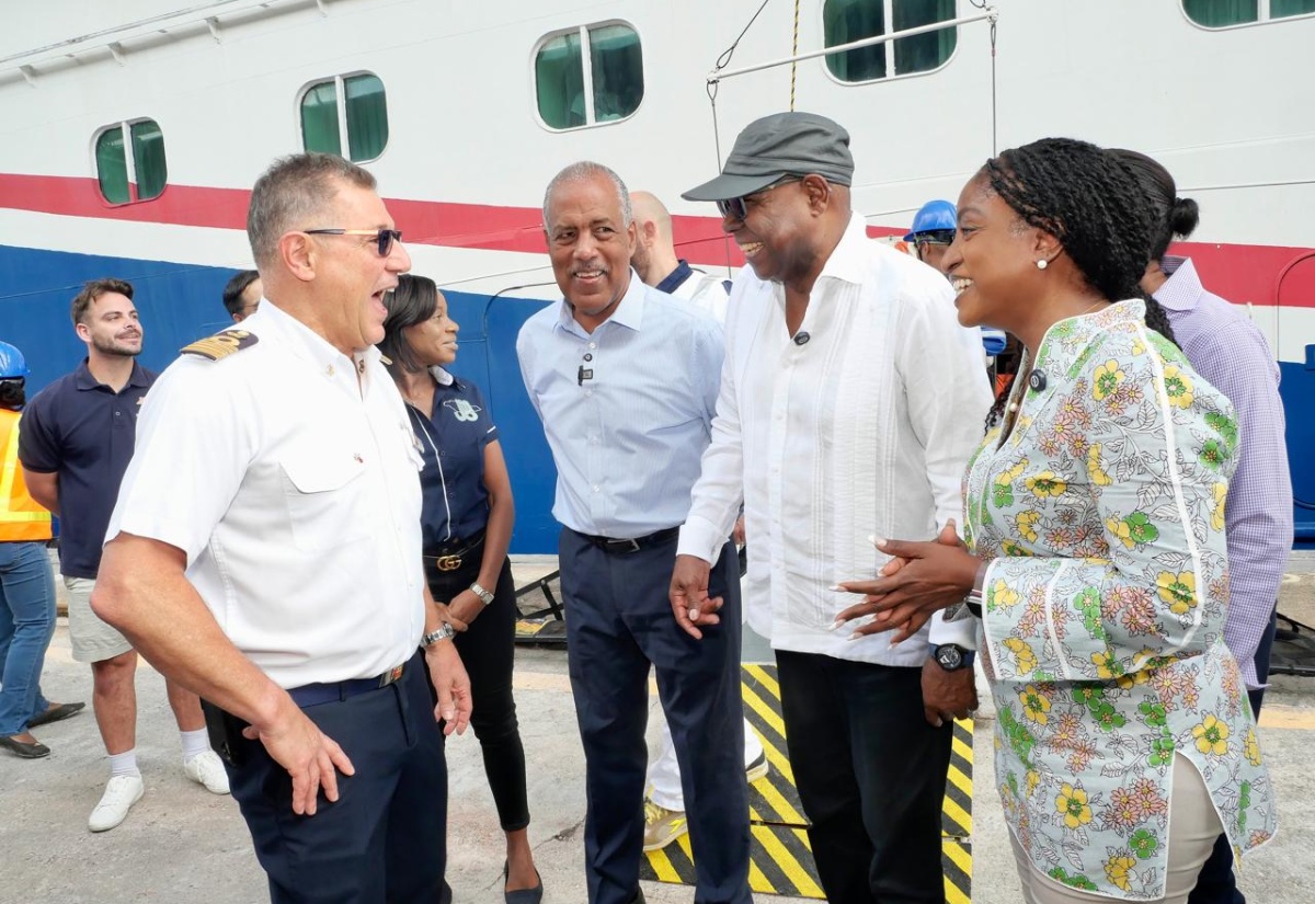 Tourism Minister, Hon Edmund Bartlett (second right), converses with Captain of the ‘Carnival Horizon’, Rocco Lubrano (left), on arrival at the Reynolds Pier, Ocho Rios, St. Ann on Tuesday (November 4) where supplies were handed over to assist with Jamaica’s Hurricane Melissa relief efforts. Others (from second left) are President and Chief Executive Officer of the Port Authority of Jamaica (PAJ) Professor Gordon Shirley; and Carnival Corporation Senior Executive, Marie McKenzie.

