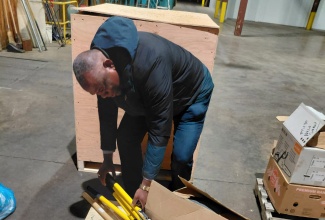 Volunteers with the Jamaican Liaison Service in Canada assemble hurricane relief items for shipment to Jamaica.