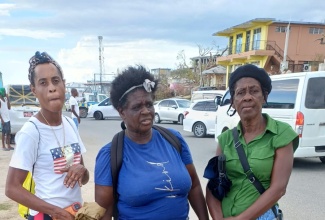 Hurricane victims, Icilda Brown (centre), Christine Burnett (left) and Angela Farquharson in the badly damaged community of Whitehouse, in Westmoreland,  on November 17.

