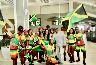 Minister of Tourism, Hon. Edmund Bartlett, shares a photo opportunity with members of the RIU Ocho Rios entertainment staff, during a tour of properties in the resort town on Thursday (November 20).