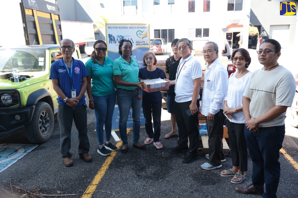 Director of Strategic Planning, Performance Monitoring and Evaluation, Western Regional Health Authority (WRHA) Abigail M. Whittaker-Clarke (second left) and WRHA Customer Service Manager and member of the staff welfare committee, Elecia Whittingham Gayle (third left), collect donation on behalf of the WRHA staff members from the Burmese Community. The handover ceremony was held on Friday (November 7), at the Freeport Business Centre in Montego Bay.