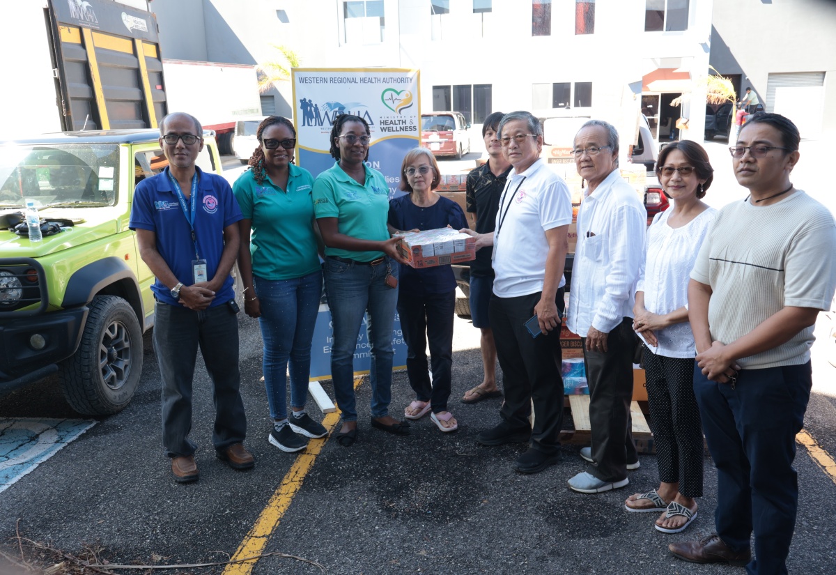 Director of Strategic Planning, Performance Monitoring and Evaluation, Western Regional Health Authority (WRHA) Abigail M. Whittaker-Clarke (second left) and WRHA Customer Service Manager and member of the staff welfare committee, Elecia Whittingham Gayle (third left), collect donation on behalf of the WRHA staff members from the Burmese Community. The handover ceremony was held on Friday (November 7), at the Freeport Business Centre in Montego Bay.