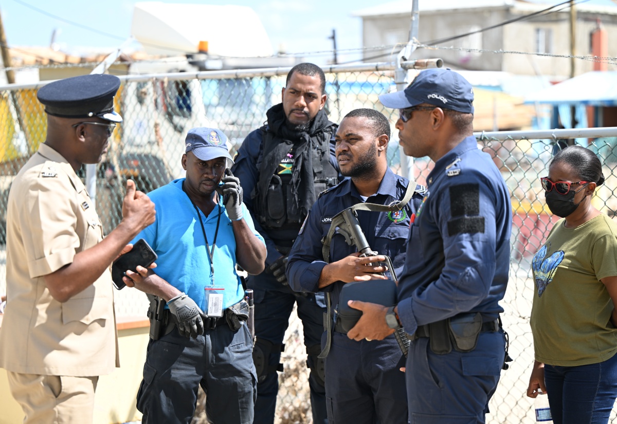 Head of the St. Elizabeth Police Division, Superintendent Coleridge Minto (left), engages in a briefing with a team of police officers at the Black River Police Station in St. Elizabeth on Tuesday, November 4.


