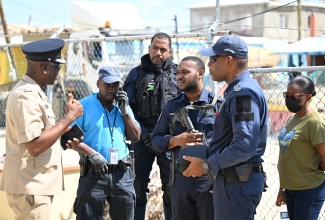 Head of the St. Elizabeth Police Division, Superintendent Coleridge Minto (left), engages in a briefing with a team of police officers at the Black River Police Station in St. Elizabeth on Tuesday, November 4.

