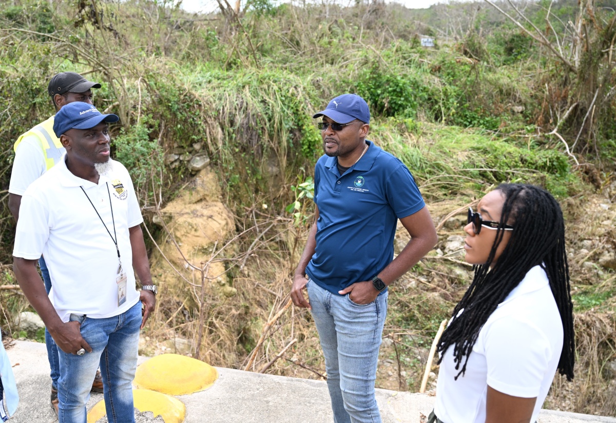 Minister without Portfolio in the Ministry of Economic Growth and Infrastructure Development with Responsibility for Works, Hon. Robert Morgan (second right), engages with State Minister in the Ministry of Tourism and Member of Parliament for Trelawny Northern, Tova Hamilton, and the National Works Agency’s (NWA) Communication and Customer Services Manager, Stephen Shaw, during a tour of the main road leading to Sherwood Content in Trelawny on Wednesday, November 5. The visit formed part of ongoing efforts to assess road cleanup operations and infrastructural damage following the passage of Hurricane Melissa.


