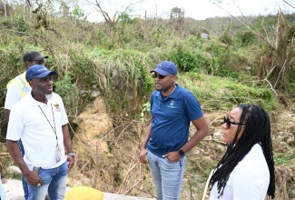 Minister without Portfolio in the Ministry of Economic Growth and Infrastructure Development with Responsibility for Works, Hon. Robert Morgan (second right), engages with State Minister in the Ministry of Tourism and Member of Parliament for Trelawny Northern, Tova Hamilton, and the National Works Agency’s (NWA) Communication and Customer Services Manager, Stephen Shaw, during a tour of the main road leading to Sherwood Content in Trelawny on Wednesday, November 5. The visit formed part of ongoing efforts to assess road cleanup operations and infrastructural damage following the passage of Hurricane Melissa.

