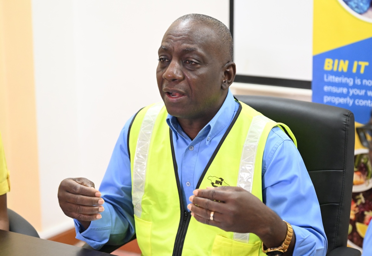 Executive Director of the National Solid Waste Management Authority (NSWMA), Audley Gordon (centre), addresses a press briefing at the WPM Waste Management Limited headquarters in Ironshore, St. James, on Monday (November 11).

