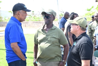 Minister of Local Government and Community Development, Hon. Desmond McKenzie (centre), converses with President and Chief Executive Officer of the Port Authority of Jamaica (PAJ), Professor Gordon Shirley (left), and Chairman of the Tourism Product Development Company (TPDCo), Ian Dear, during a visit to Falmouth, Trelawny, on Saturday (November 29).

