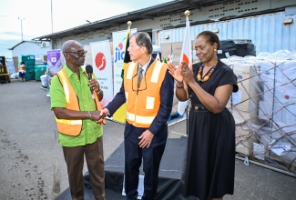 Minister of Local Government and Community Development, Hon. Desmond McKenzie (left), thanks Ambassador of Japan to Jamaica, His Excellency Yasuhiro Atsumi (centre), for relief supplies that arrived from that country at the Norman Manley International Airport (NMIA), on November 5. At right is Permanent Secretary in the Ministry of Foreign Affairs and Foreign Trade, Ambassador Sheila Sealy Monteith.

