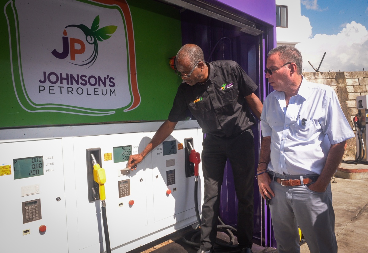 Minister of Energy, Transport and Telecommunications, Hon. Daryl Vaz (right), looks on as Technical Officer, Johnson’s Petroleum, Adrian Samuels, points out the features of one of the company’s mobile gas stations during his visit to Johnson’s Petroleum Headquarters on Beechwood Avenue in Kingston on Wednesday (November 2). The company has acquired 10 mobile units, which will be deployed to hurricane-impacted parishes.

