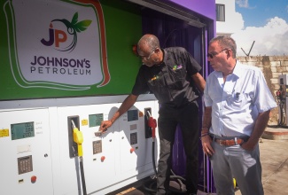 Minister of Energy, Transport and Telecommunications, Hon. Daryl Vaz (right), looks on as Technical Officer, Johnson’s Petroleum, Adrian Samuels, points out the features of one of the company’s mobile gas stations during his visit to Johnson’s Petroleum Headquarters on Beechwood Avenue in Kingston on Wednesday (November 2). The company has acquired 10 mobile units, which will be deployed to hurricane-impacted parishes.
