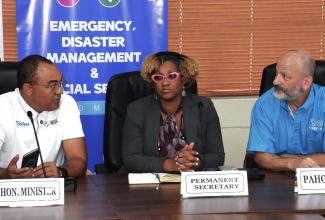 Minister of Health and Wellness, Dr. Hon Christopher Tufton (left), consults with Acting Permanent Secretary, Kadian Birch, and Pan American Health Organization/World Health Organization (PAHO/WHO) Representative to Jamaica, Bermuda, and the Cayman Islands, Ian Stein, during a press conference held on Saturday (November 1) at the Health Emergency Operations Centre (EOC) on Knutsford Boulevard, New Kingston. The briefing addressed the status of the public health system following the passage of Hurricane Melissa.