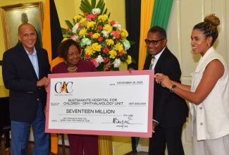 Minister of Culture, Gender, Entertainment and Sport, Hon. Olivia Grange (second left), and Chairman of the ‘Come Alive Collective’, Eric Hosin (left), present a cheque valued $17 million to Chief Executive Officer of the Bustamante Hospital for Children, Anthony Wood, and Consultant Ophthalmologist, Dr. Kristin Cowan-Lyn. The donation, derived from the $28-million net proceeds of the CeCe Winans ‘More Than This’ concert staged on Emancipation Day, August 1, will support the hospital’s Ophthalmology Unit. The official handover ceremony was held on Wednesday (November 26) at King’s House


