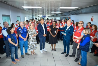 Minister of Health and Wellness, Dr. the Hon. Christopher Tufton (fourth left), listens to a point being made by Spain’s Ambassador to Jamaica, His Excellency José María Fernández López de Turiso (third right), at a welcoming ceremony for over 70 medical professionals from Spain, held at the Norman Manley International Airport (NMIA) in Kingston, on November 5. Country Representative with the Pan-American Health Organization (PAHO), Ian Stein (second left); European Union (EU) Ambassador to Jamaica, Her Excellency Dr. Erja Askola (third left), and Permanent Secretary in the Ministry of Foreign Affairs and Foreign Trade, Ambassador Sheila Sealy Monteith (fifth left), are also pictured.