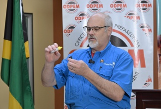 Founder and Chief Executive Officer of WaterStep, Mark Hogg, demonstrates the process of making medical-grade bleach on site during Tuesday’s (November 18) handover ceremony for 300 bleach makers to the country