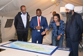Minister without Portfolio in the Office of the Prime Minister with responsibility for Efficiency, Innovation and Digital Transformation, Ambassador Audrey Marks (second right) engages in conversation with (from left) Canada