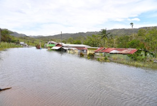 Rising water levels at Content in Williamsfield, Manchester, which have inundated homes and business establishments.

