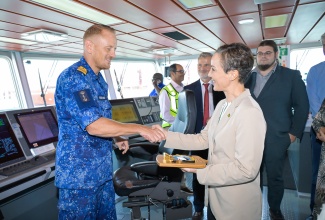 Minister of Foreign Affairs and Foreign Trade, Senator the Hon. Kamina Johnson Smith (right), greets Captain of the HNLMS Pelikaan, Lieutenant Commander Max Borsboom. The Dutch Navy support ship, which brought relief supplies to the island, docked at the Kingston Freeport Container Terminal on Tuesday (November 4). 