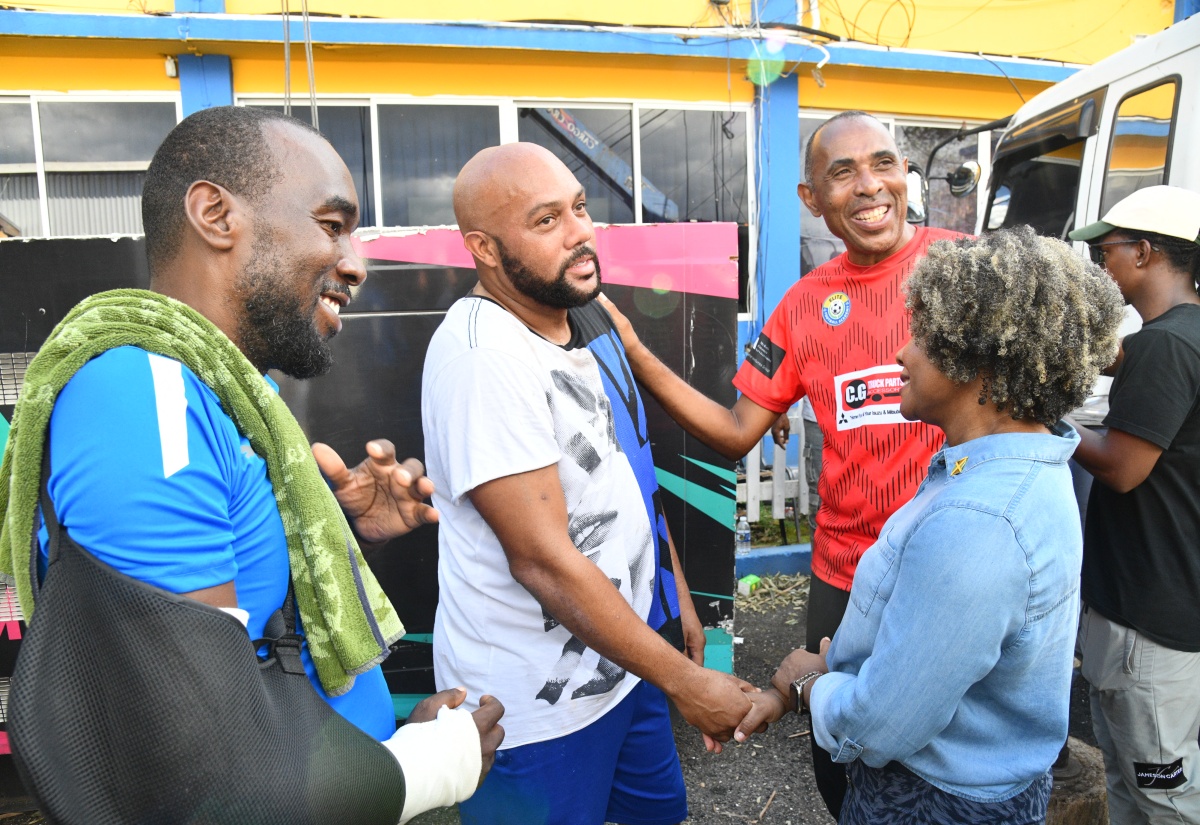 Minister of Education, Skills, Youth and Information, Senator Dr. the Hon. Dana Morris Dixon (right), greets Santa Cruz-based businessman, Edward Hines (second left), during a visit to the St. Elizabeth Technical High School on Sunday (November 2). Sharing the moment (from left) are Chairman of the school, Yaneke Watson and Principal, Keith Wellington. Mr. Hines was instrumental in facilitating the contribution of a generator by Romeich Major of Romeich Entertainment for the pumping of water to serve the institution and the wider community.

