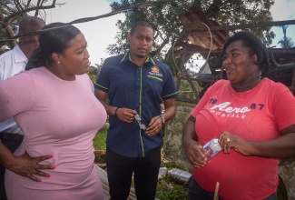 Minister of Agriculture, Fisheries and Mining, Hon. Floyd Green (second right); State Minister, Hon. Franklin Witter (second left) and St. Catherine North Eastern Member of Parliament, Hon. Kerensia Morrison (left), listen intently as poultry farmer, Maureen Simmonds, relays the extensive damage to her business from Hurricane Melissa. The officials visited Bonnet District, Guys Hill in St. Catherine on Thursday (November 20), to tour several farms in the community that were damaged during the storm, as part of the Ministry’s hurricane recovery plan. The tour culminated with a farmers’ meeting at the Guys Hill Town Hall, where farmers received irish potato seeds, fertilisers and vegetable seeds.