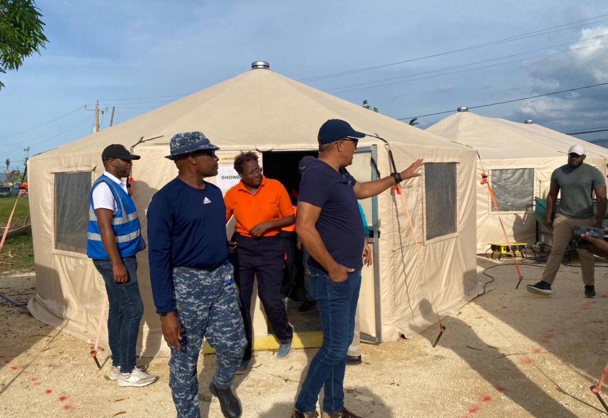 Minister of Health and Wellness, Dr. the Hon. Christopher Tufton (right, foreground), discusses the utilisation of space with Barbados Defence Force Emergency Medical Team (EMT) Leader, Lieutenant Commander Anderson Goodridge (second left), during his visit on Friday (November 28), to the Barbados Field Hospital, established on the grounds of the Savanna-la-Mar Public General Hospital in Westmoreland.

