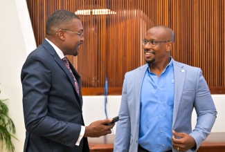 Minister without Portfolio in the Ministry of Economic Growth and Infrastructure Development with responsibility for Works, Hon. Robert Morgan (left), in discussion with President, Incorporated Masterbuilders Association of Jamaica (IMAJ), Richard Mullings, during the IMAJ’s seminar held at the Jamaica Conference Centre, in downtown Kingston, on November 25.

