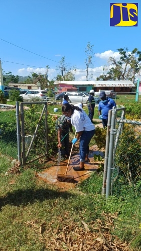 Staff of the St. Elizabeth Infirmary, located in Santa Cruz, St. Elizabeth, participate in clean-up activities at the facility on November 27.