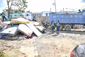 Team members of the National Solid Waste Management Authority (NSWMA) carry out clean-up activities in Catherine Hall, St. James on Tuesday (Nov. 4).