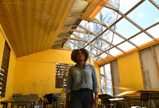 Minister of Education, Skills, Youth and Information, Senator Dr. the Hon. Dana Morris Dixon, looks at damage to a classroom at the Manchester-based Holmwood Technical High School, during a visit to the institution on November 2.