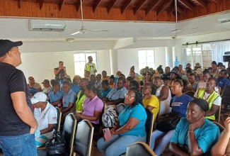 Minister of Health and Wellness, Dr. the Hon. Christopher Tufton, addresses a recent meeting with public health workers at Hotel Commingle in Savanna-la-Mar, Westmoreland.

