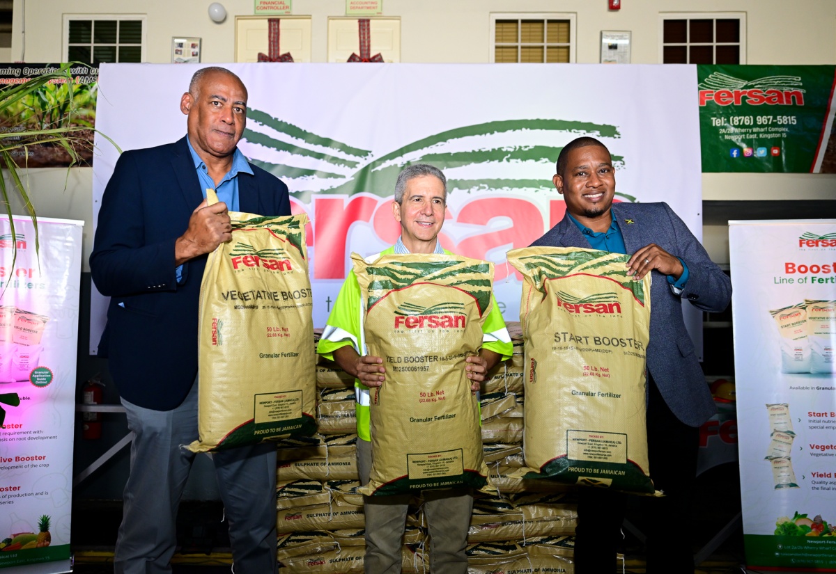 Minister of Agriculture, Fisheries and Mining, Hon. Floyd Green (right), shares in the symbolic handover of fertiliser by Newport-Fersan (Jamaica) Limited with the company’s Managing Director, Dennis Valdez (centre), and Chairman of the Agriculture Ministry’s Hurricane Melissa Recovery Task Force, Michael Pryce. The occasion was Newport-Fersan’s Hurricane Melissa Support Handover Ceremony, held on Thursday (December 11) at the fertiliser company’s headquarters in Kingston. Newport-Fersan donated $25 million worth of fertiliser (over 7,000 bags), to be distributed to farmers who were severely impacted by the major category-five storm.

