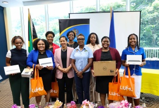 Minister of State in the Ministry of National Security and Peace, Hon. Juliet Cuthbert Flynn (front row, third right), and Resident Representative of the Organization of American States (OAS) Office of the General Secretariat in Jamaica, Jeanelle van Glannen Weygel (front row, third left), join winners of the ‘SheSecures’ Jamaica Cybersecurity Competition for a photo opportunity during the recent awards ceremony at the University of the West Indies (UWI) Regional Headquarters in Mona, St. Andrew.

