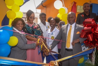 Technical Support Officer at the Ministry of Education, Skills, Youth and Information, Dr. Nahema Daniels Heath (second left), cuts the ribbon to open a smart greenhouse at the José Martí Technical High School in St. Catherine on Friday (Dec. 5). Joining her (from left) are: Regional Director for the Ministry