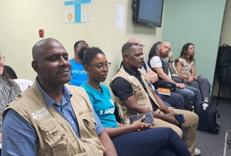 Team lead of the Caribbean Community (CARICOM) Operations Support Team, Caribbean Disaster Emergency Management Agency (CDEMA), Major General Rodney Smart (left) listens keenly during Monday’s (December 1) briefing at the National Emergency Operations Centre (NEOC) located at the Office of Disaster Preparedness and Emergency Management (ODPEM).

