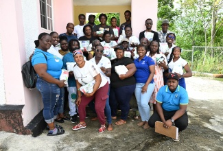 Cedar Valley farmers in St. Thomas proudly display post-Hurricane Melissa crop-recovery kits received on December 9, to aid recovery efforts following Hurricane Melissa.

