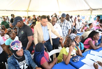 Prime Minister, Dr. the Most Hon. Andrew Holness (second left), is joined by Minister of Labour and Social Security, Hon. Pearnel Charles Jr. (third left), as they greet residents of Black River in St. Elizabeth at the ‘Solidarity Live: Community Engagement’  event, at Dunn’s Auto World, Black River, St. Elizabeth, on December 12.

