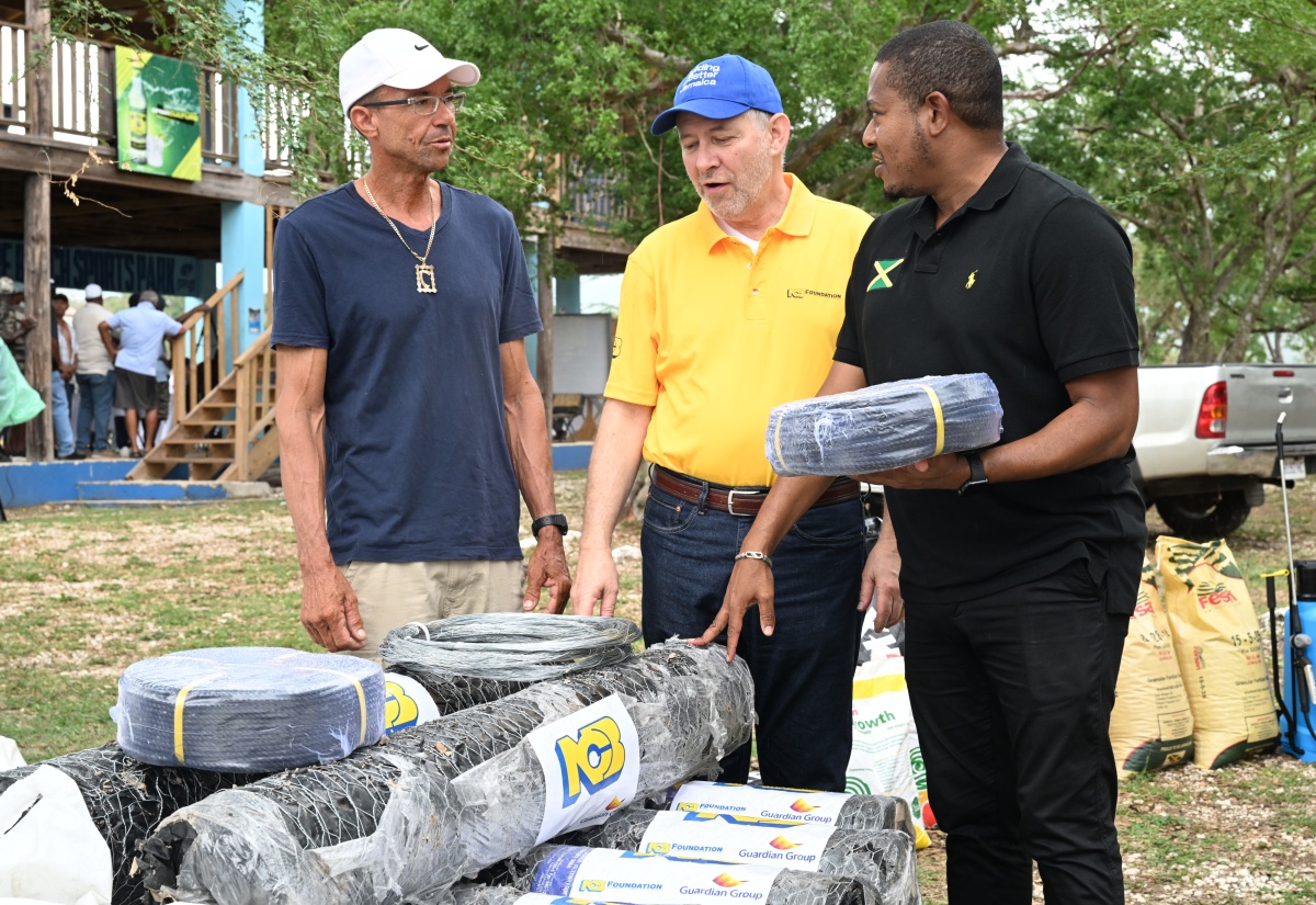 Minister of Agriculture, Fisheries and Mining, Hon. Floyd Green (right), interacts with Chief Executive Officer of NCB Foundation Jamaica Limited, Bruce Bowen (centre), and fisherman, Gervon Parchment, as they inspect fishing wires during the distribution of agricultural and fishing supplies at the Breds Foundation Complex in Treasure Beach, St. Elizabeth, on Tuesday (December 23), as part of post-Hurricane Melissa recovery efforts.

