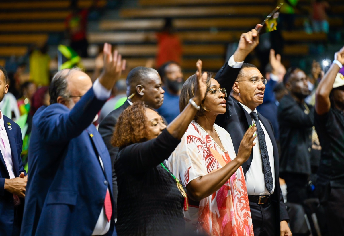 Prime Minister, Dr. the Most Hon. Andrew Holness (right); and his wife and Speaker of the House, the Most Hon. Juliet Holness (second right), take part in the service of celebration for the life of the late Hon. James “Jimmy Cliff” Chambers, OM, inside the National Indoor Sports Centre in Independence Park, on Wednesday (December 17). Also participating are Minister of Culture, Gender, Entertainment and Sport, Hon. Olivia Grange; and Leader of the Opposition, Mark Golding.

