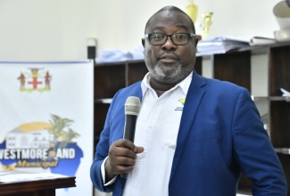 Regional Operations Manager, WPM Waste Management Ltd., Dramaine Jones, addresses the recent monthly meeting of the Westmoreland Municipal Corporation.

